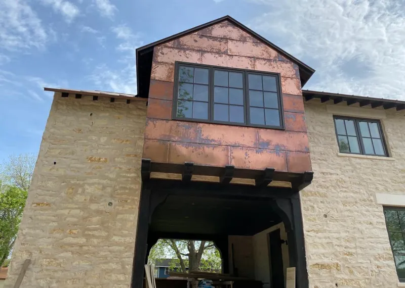 Copper metal panel facade on a stone building for Metal Roof Coating in Spencer